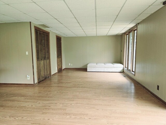 38W443 Woodhill Ln, Saint Charles, IL 60175 - unfurnished living room with baseboards, light wood-type flooring, and a paneled ceiling