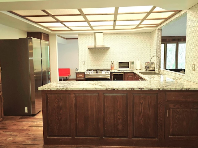 38W443 Woodhill Ln, Saint Charles, IL 60175 - kitchen with wall chimney range hood, appliances with stainless steel finishes, a sink, a peninsula, and wood finished floors