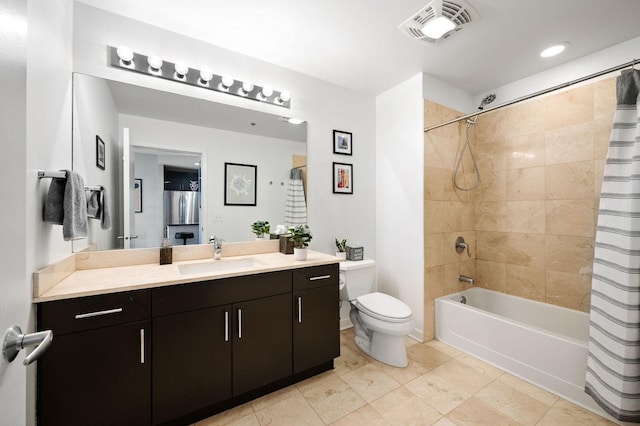 bathroom featuring visible vents, tile patterned flooring, shower / bath combo, vanity, and toilet