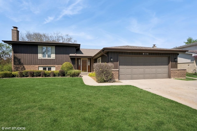 view of front of property with a front lawn, brick siding, a garage, a chimney, and concrete driveway