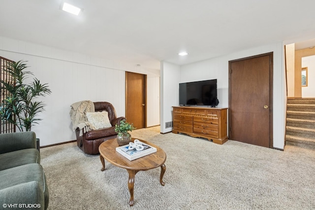 living room with carpet flooring and stairs