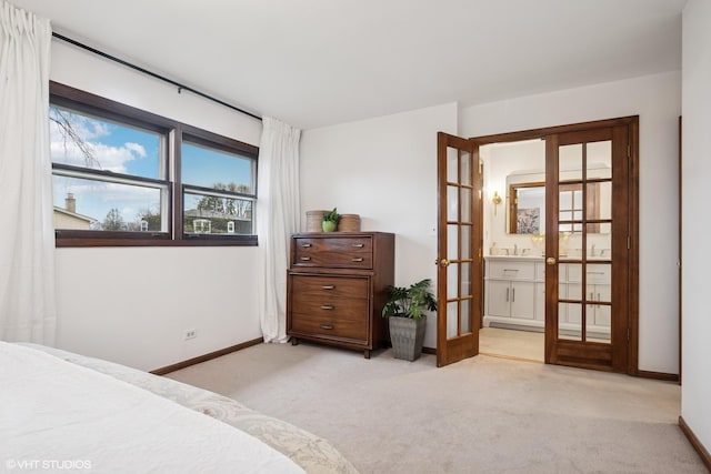 bedroom with baseboards, light carpet, and french doors