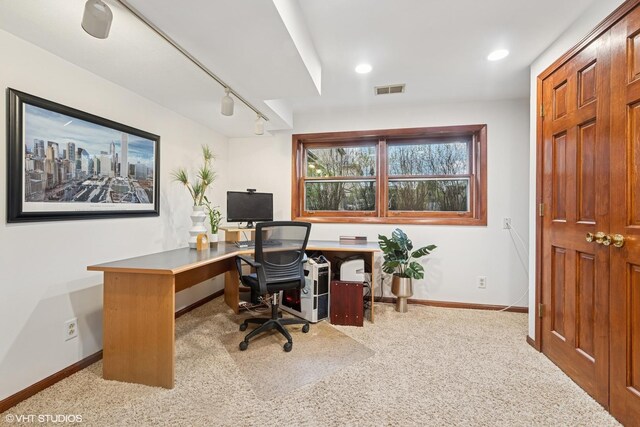 office with track lighting, carpet floors, baseboards, and visible vents