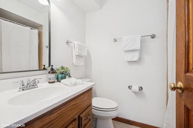 bathroom featuring vanity, tile patterned flooring, and toilet