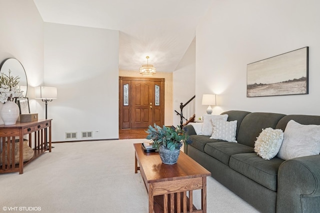 living room with stairway, visible vents, baseboards, and carpet