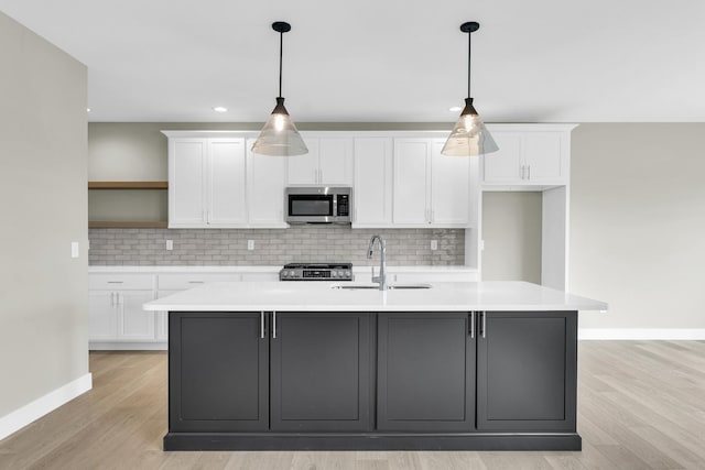 407 Sutton St, Savoy, IL 61874 - kitchen featuring stainless steel appliances, a sink, open shelves, white cabinets, and recessed lighting