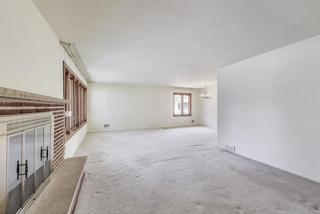 621 N Hamlin Ave, Park Ridge, IL 60068 - unfurnished living room featuring a notable chandelier, a fireplace, light colored carpet, and visible vents