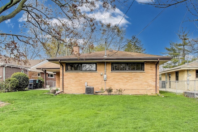621 N Hamlin Ave, Park Ridge, IL 60068 - rear view of house featuring fence, cooling unit, a chimney, brick siding, and a yard