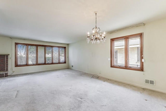 621 N Hamlin Ave, Park Ridge, IL 60068 - carpeted spare room featuring visible vents, baseboards, and a notable chandelier