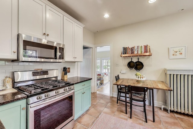 kitchen featuring stainless steel appliances, decorative backsplash, white cabinets, recessed lighting, and light tile patterned floors