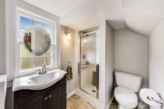 bathroom with a stall shower, baseboards, vanity, toilet, and vaulted ceiling
