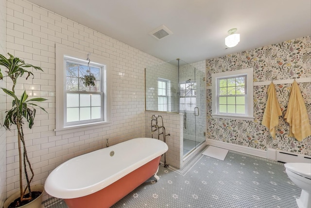 full bathroom with tile patterned floors, a stall shower, a baseboard heating unit, wallpapered walls, and a soaking tub