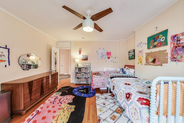 bedroom featuring wood finished floors, crown molding, and ceiling fan