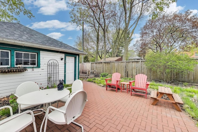 view of patio with a fenced backyard and outdoor dining area