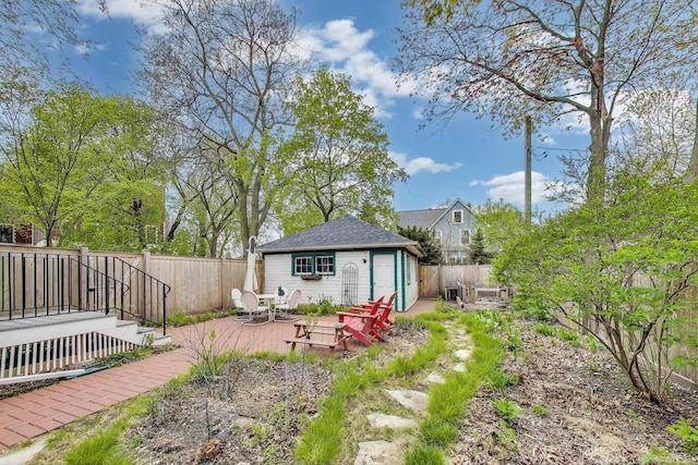 fenced backyard featuring an outdoor structure and a patio area