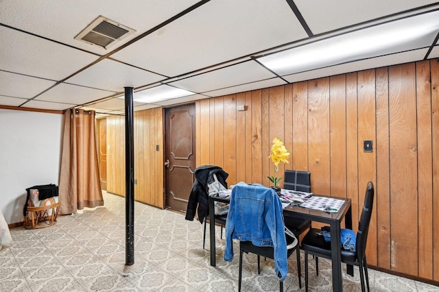 5058 S Ridgeway Ave, Chicago, IL 60632 - dining room featuring visible vents, light floors, a drop ceiling, and wooden walls