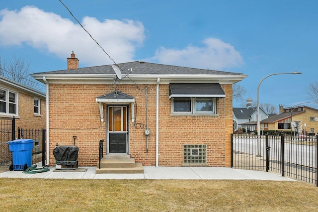 5058 S Ridgeway Ave, Chicago, IL 60632 - rear view of house featuring brick siding, a lawn, fence, and a chimney