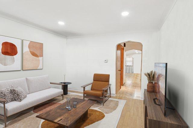 5058 S Ridgeway Ave, Chicago, IL 60632 - living room featuring crown molding, arched walkways, recessed lighting, and light wood-type flooring
