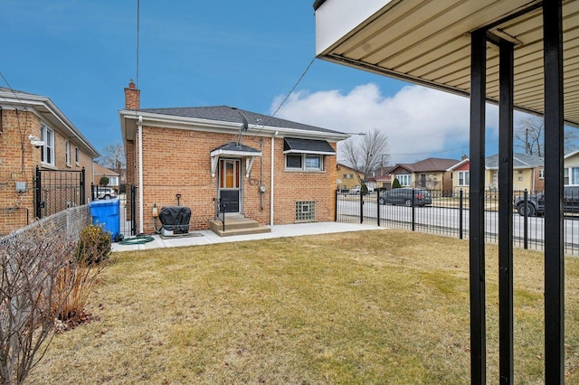 5058 S Ridgeway Ave, Chicago, IL 60632 - rear view of house with a lawn, a residential view, brick siding, a patio, and entry steps