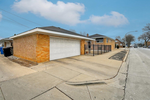 5058 S Ridgeway Ave, Chicago, IL 60632 - view of property exterior featuring brick siding, fence, and a garage