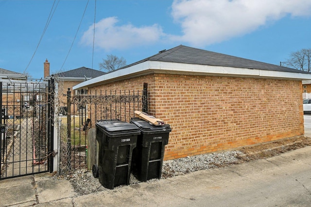 5058 S Ridgeway Ave, Chicago, IL 60632 - view of property exterior featuring fence, a gate, and brick siding