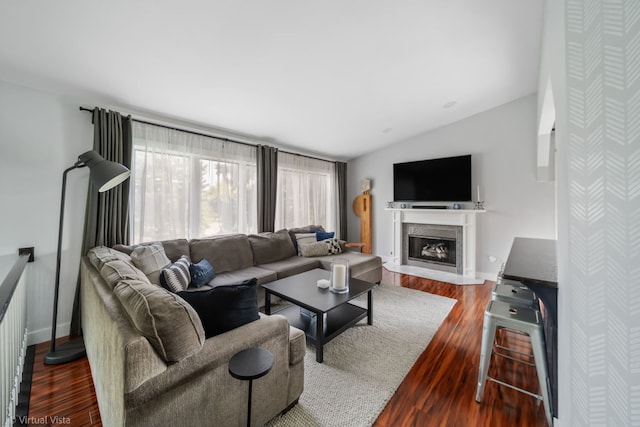 2305 Olde Mill Rd Unit 2305, Plainfield, IL 60586 - living room with a glass covered fireplace, baseboards, vaulted ceiling, and wood finished floors