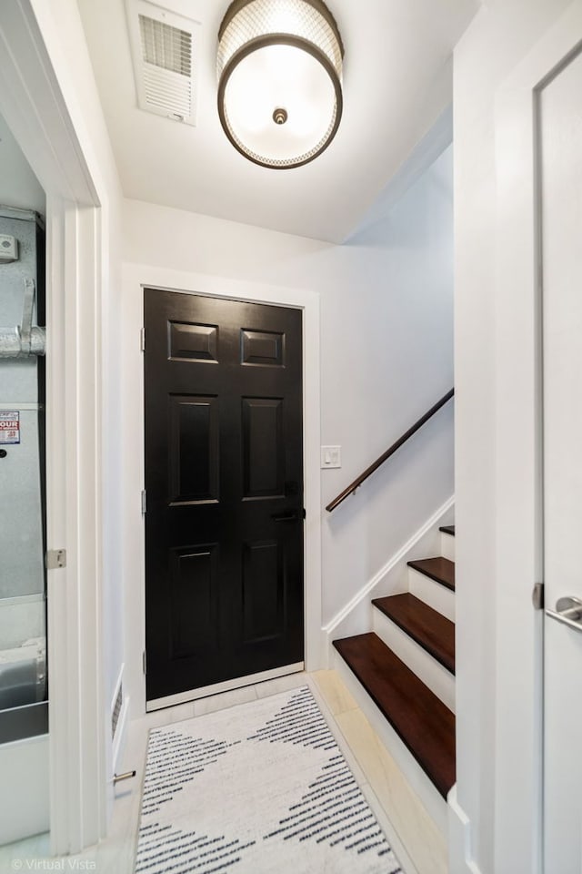 2305 Olde Mill Rd Unit 2305, Plainfield, IL 60586 - tiled entrance foyer featuring visible vents, baseboards, and stairway