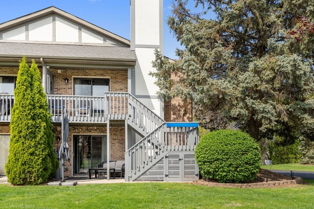 2305 Olde Mill Rd Unit 2305, Plainfield, IL 60586 - back of property featuring stairs, brick siding, a chimney, covered porch, and a yard