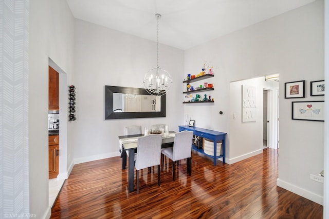 2305 Olde Mill Rd Unit 2305, Plainfield, IL 60586 - dining room with baseboards, a notable chandelier, wood finished floors, and a towering ceiling