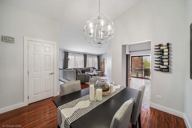 2305 Olde Mill Rd Unit 2305, Plainfield, IL 60586 - dining room with an inviting chandelier, baseboards, a high ceiling, and wood finished floors