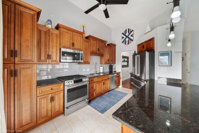 2305 Olde Mill Rd Unit 2305, Plainfield, IL 60586 - kitchen featuring a sink, brown cabinets, tasteful backsplash, a ceiling fan, and appliances with stainless steel finishes