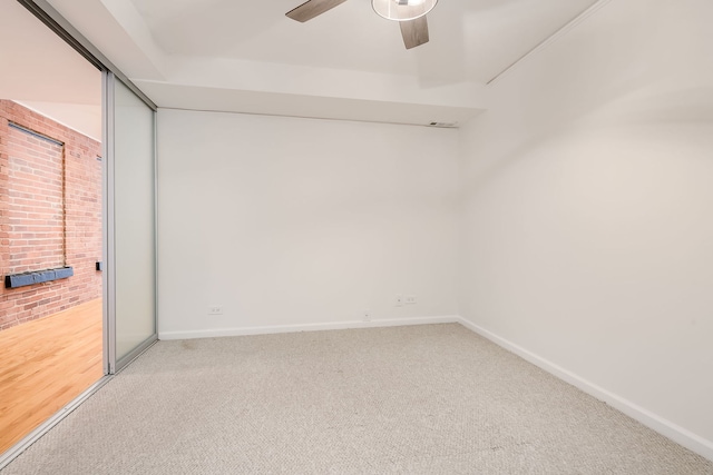 unfurnished bedroom featuring carpet flooring, baseboards, access to exterior, and ceiling fan