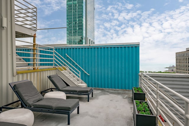 balcony with stairway and a patio