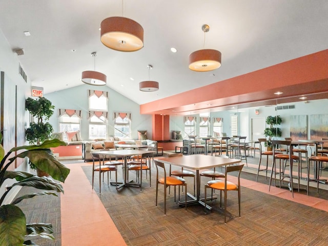 dining space with high vaulted ceiling