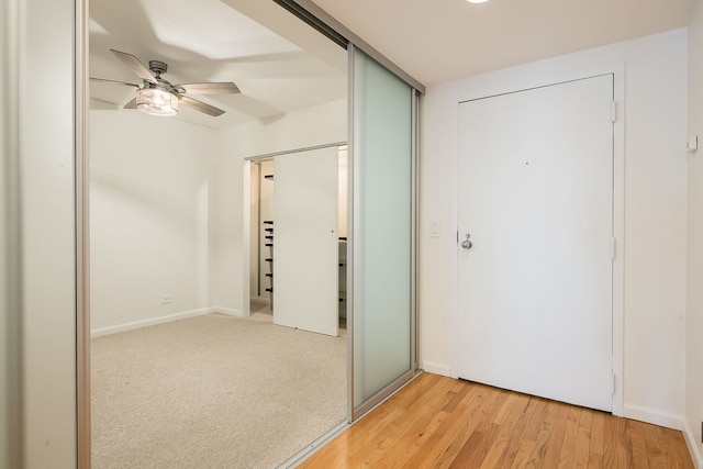 unfurnished bedroom featuring light wood-style flooring and a ceiling fan