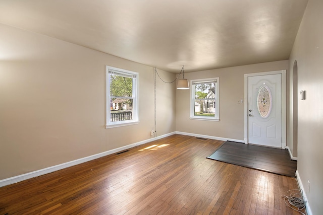 566 N 10th Ave, Kankakee, IL 60901 - entrance foyer featuring wood-type flooring, baseboards, and arched walkways
