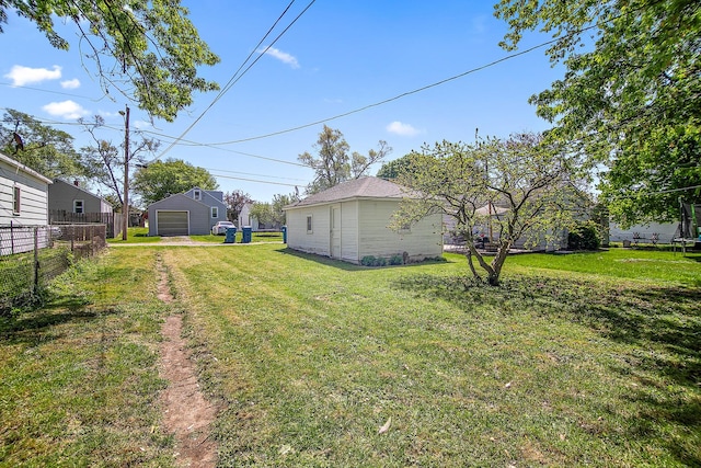 566 N 10th Ave, Kankakee, IL 60901 - view of yard with a detached garage, an outbuilding, and driveway