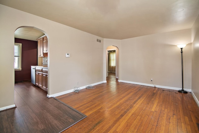 566 N 10th Ave, Kankakee, IL 60901 - spare room with arched walkways, dark wood finished floors, and baseboards