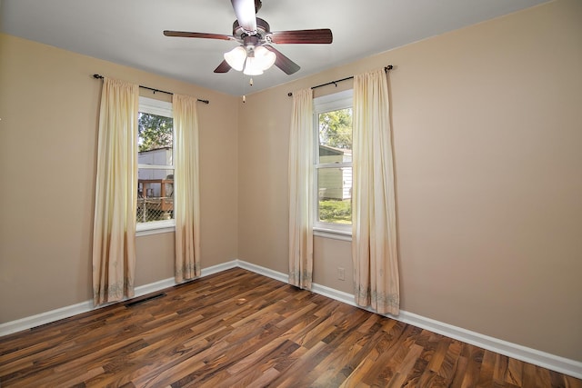 566 N 10th Ave, Kankakee, IL 60901 - spare room featuring dark wood-type flooring, plenty of natural light, and baseboards
