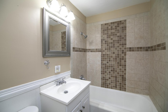 566 N 10th Ave, Kankakee, IL 60901 - bathroom featuring shower / bathtub combination, vanity, toilet, and wainscoting