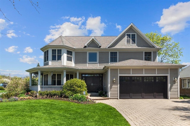 845 Woodward Ave, Deerfield, IL 60015 - view of front of house with decorative driveway, a front yard, and a porch