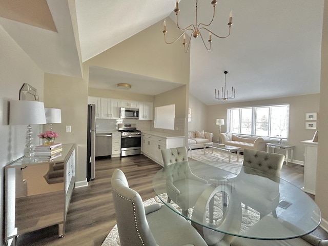 dining area with baseboards, a notable chandelier, high vaulted ceiling, and dark wood-type flooring