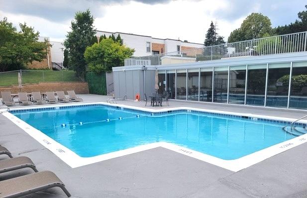 community pool with fence and a patio