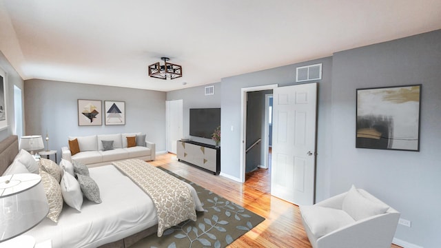 bedroom with visible vents, light wood-style flooring, and baseboards