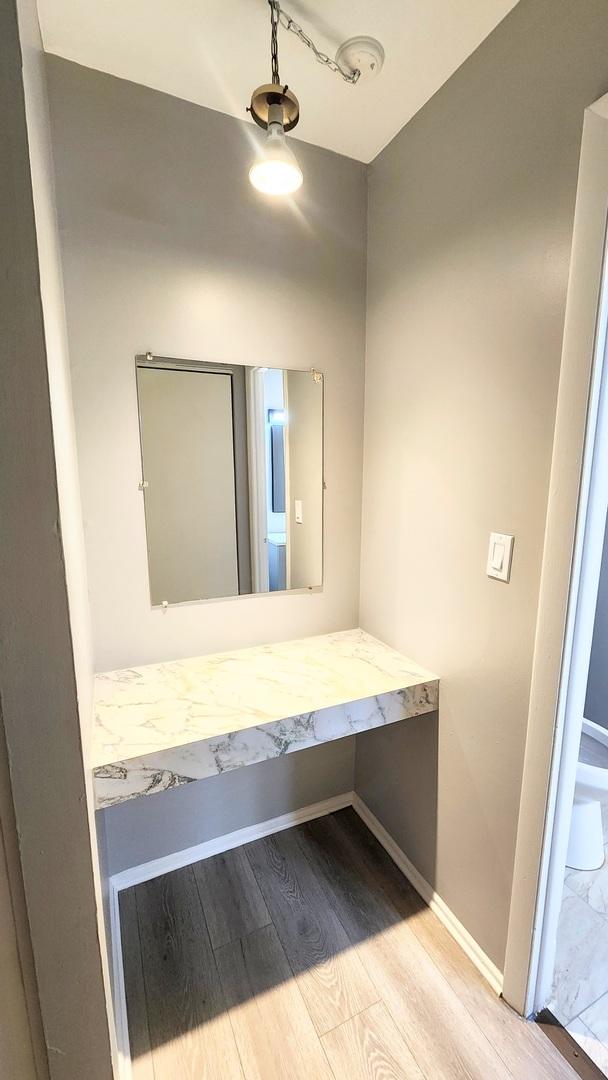 interior space featuring baseboards and wood finished floors