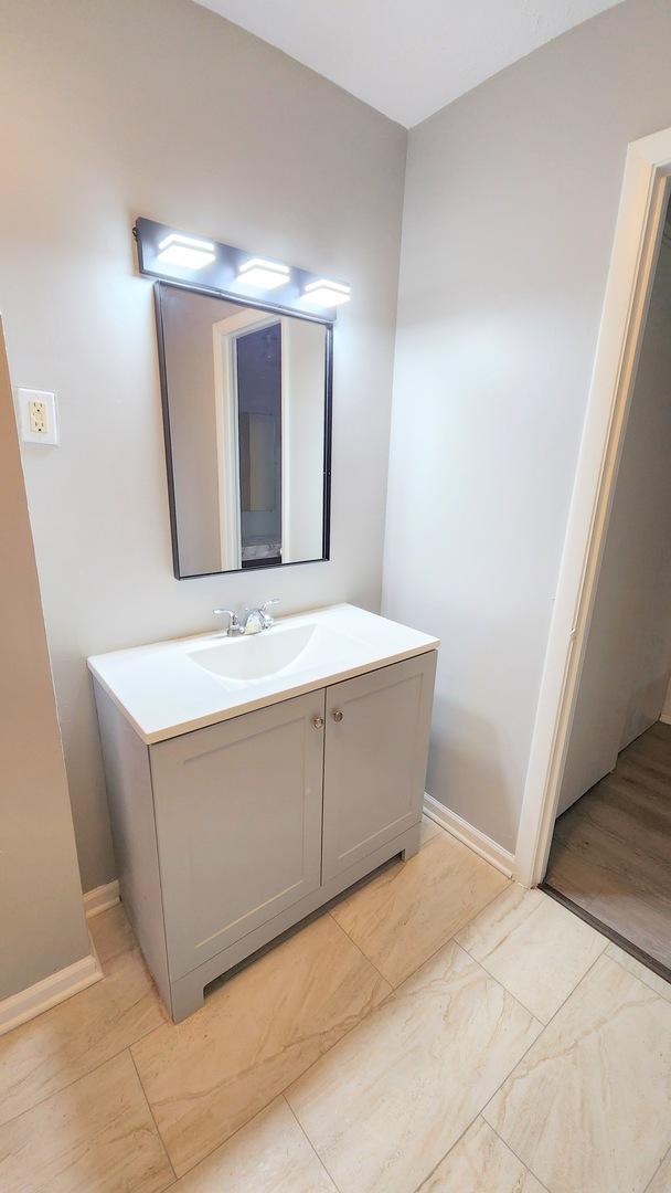 bathroom featuring baseboards and vanity
