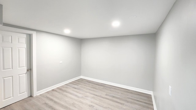 basement featuring baseboards, recessed lighting, and light wood-style flooring