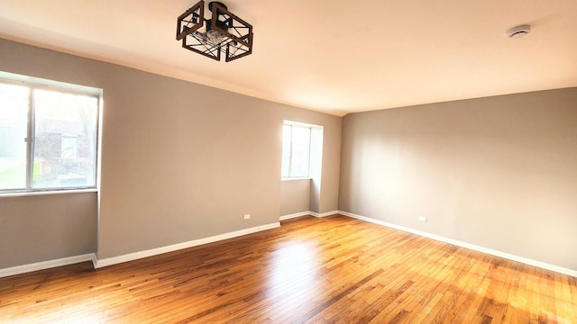 unfurnished room featuring baseboards and wood finished floors