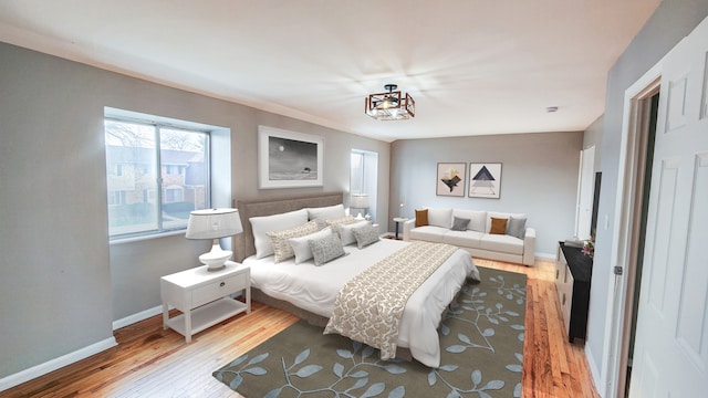 bedroom with baseboards and hardwood / wood-style flooring