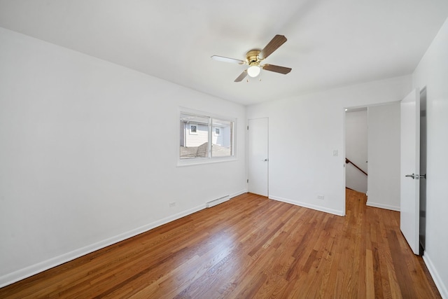 unfurnished bedroom with visible vents, baseboards, and wood finished floors